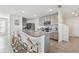 Modern kitchen boasting a granite island with seating, stainless steel appliances, and gray cabinets at 16614 Mosaic Oar Dr, Wimauma, FL 33598