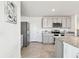 Modern kitchen featuring stainless steel appliances, gray cabinetry, granite counters and tile floors at 16614 Mosaic Oar Dr, Wimauma, FL 33598