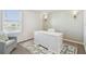 Bright office with an accent wall, desk, and a cozy chair near the window at 16614 Mosaic Oar Dr, Wimauma, FL 33598