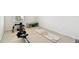 A home gym with rower, yoga mat, kettlebells and a weight bench on top of puzzle piece flooring at 16614 Mosaic Oar Dr, Wimauma, FL 33598