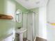 Bright bathroom featuring a shower stall, pedestal sink and accent shelving at 1700 30Th N Ave, St Petersburg, FL 33713