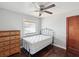 Minimal bedroom with a double bed, wooden dresser and hardwood floor at 1700 30Th N Ave, St Petersburg, FL 33713