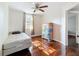Bedroom with refinished hardwood flooring, ceiling fan and natural light at 1700 30Th N Ave, St Petersburg, FL 33713