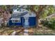 Charming blue home with white trim, complemented by mature landscaping and a welcoming entrance at 1700 30Th N Ave, St Petersburg, FL 33713