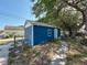 View of the backyard shed with blue siding, white trim and landscaping at 1700 30Th N Ave, St Petersburg, FL 33713