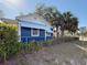 Charming home exterior with blue siding, well-maintained landscape, and shade trees at 1700 30Th N Ave, St Petersburg, FL 33713