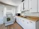 Traditional kitchen with white cabinets, wood countertops and modern amenities at 1700 30Th N Ave, St Petersburg, FL 33713