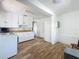 Spacious kitchen with white cabinets, wood-look flooring and ample counter space at 1700 30Th N Ave, St Petersburg, FL 33713