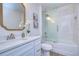 Elegant bathroom featuring a shower-over-tub, stylish vanity, and a gold-framed mirror at 1702 E Frierson Ave, Tampa, FL 33610