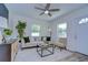 Bright living room with wood-look floors, modern furnishings, and plenty of natural light at 1702 E Frierson Ave, Tampa, FL 33610