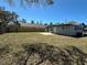 A large, grassy backyard with a newly built patio and privacy fence creates an outdoor space at 1913 Park Ave, Tarpon Springs, FL 34689