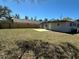 Large backyard featuring a new fence, grass, and a patio that is perfect for entertaining at 1913 Park Ave, Tarpon Springs, FL 34689