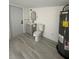 Bathroom with standard toilet and sink next to a water heater at 1913 Park Ave, Tarpon Springs, FL 34689
