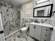 Modern bathroom features marble tile, a vanity with black hardware, and a shower at 1913 Park Ave, Tarpon Springs, FL 34689