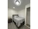 Cozy bedroom featuring wood-look flooring, a nightstand with a lamp, and a closet at 1913 Park Ave, Tarpon Springs, FL 34689