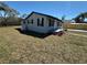 A well-maintained home features a freshly painted exterior and a spacious lawn at 1913 Park Ave, Tarpon Springs, FL 34689