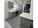 Modern kitchen featuring gray cabinetry, stainless steel appliances, and quartz countertops at 1913 Park Ave, Tarpon Springs, FL 34689