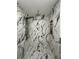 Walk-in shower with marble tile and modern showerhead at 1913 Park Ave, Tarpon Springs, FL 34689