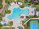 Overhead view of community pool, tennis courts, lounge chairs, umbrellas and picnic structures at 19445 Redwood Point Dr, Tampa, FL 33647