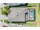 Aerial view of a home with a screened-in pool, patio furniture, and a fenced-in backyard at 19445 Redwood Point Dr, Tampa, FL 33647