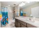 Well-lit bathroom featuring a shower-tub combo with a fun shower curtain and a modern vanity with ample counter space at 19445 Redwood Point Dr, Tampa, FL 33647