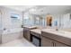 Bright bathroom with double vanity, soaking tub, and large mirror at 19445 Redwood Point Dr, Tampa, FL 33647