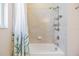 Bright bathroom features a tub with tile surround and a handheld shower head at 19445 Redwood Point Dr, Tampa, FL 33647