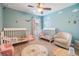 Charming bedroom with two toddler beds, decorative wall decals, and a comfortable chair creating a cheerful space at 19445 Redwood Point Dr, Tampa, FL 33647