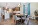 Eat-in kitchen with modern lighting, breakfast nook with a round table, and view to the kitchen and breakfast bar at 19445 Redwood Point Dr, Tampa, FL 33647