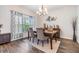 Formal dining room with wood floors, stylish lighting, and designer curtains, offering a warm ambiance at 19445 Redwood Point Dr, Tampa, FL 33647
