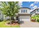Charming two-story home with a two-car garage, manicured landscaping, and a paver driveway at 19445 Redwood Point Dr, Tampa, FL 33647