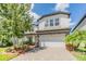 Charming two-story home with a two-car garage, manicured landscaping, and a paver driveway at 19445 Redwood Point Dr, Tampa, FL 33647