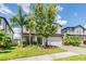 A beautiful two-story home featuring lush landscaping and a welcoming front entrance at 19445 Redwood Point Dr, Tampa, FL 33647