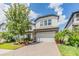 Charming two-story home with a two-car garage, manicured landscaping, and a paver driveway at 19445 Redwood Point Dr, Tampa, FL 33647