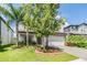 Attractive two-story home with mature trees, manicured flowerbeds, and a clean, modern facade at 19445 Redwood Point Dr, Tampa, FL 33647