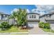 Beautiful two-story home featuring a paver driveway, stone accents, and mature landscaping at 19445 Redwood Point Dr, Tampa, FL 33647