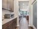 Open kitchen with stainless appliances and wood flooring flowing towards the dining area at 19445 Redwood Point Dr, Tampa, FL 33647