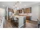 Modern kitchen featuring a center island with seating, stainless steel appliances, and pendant lighting at 19445 Redwood Point Dr, Tampa, FL 33647