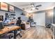 Cozy living room with hardwood floors, desk, two comfortable chairs, ceiling fan, and stylish decor at 19445 Redwood Point Dr, Tampa, FL 33647