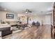 Spacious living room with dark wood floors, ceiling fan, and neutral-colored furniture at 19445 Redwood Point Dr, Tampa, FL 33647