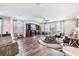 Bright and airy living room with wood floors, ceiling fan and large windows at 19445 Redwood Point Dr, Tampa, FL 33647
