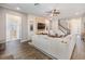 Inviting living room with wood-look tile flooring, comfortable seating, TV, and view to the stairway and front entry at 19445 Redwood Point Dr, Tampa, FL 33647