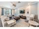 Comfortable living room with a large sectional sofa, stylish decor, and access to the screened-in patio at 19445 Redwood Point Dr, Tampa, FL 33647