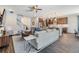 Spacious living room with an open floor plan, connected to the kitchen, breakfast bar, and stairwell to the second floor at 19445 Redwood Point Dr, Tampa, FL 33647