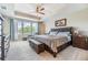 Spacious main bedroom features a tray ceiling, ceiling fan, and large windows at 19445 Redwood Point Dr, Tampa, FL 33647