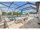 Charming screened-in patio with outdoor dining setup, perfect for al fresco meals and poolside relaxation at 19445 Redwood Point Dr, Tampa, FL 33647