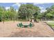 A vibrant playground with various play structures, swings, and a safe, cushioned ground at 19445 Redwood Point Dr, Tampa, FL 33647