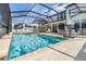 Stunning screened-in pool and patio area, showcasing outdoor lounging and dining spaces for relaxing and entertaining at 19445 Redwood Point Dr, Tampa, FL 33647