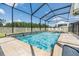 Inviting screened-in pool and spa with beautiful blue water, surrounded by lounge chairs for relaxing outdoors at 19445 Redwood Point Dr, Tampa, FL 33647