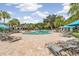 A sparkling community pool surrounded by lounge chairs and shaded cabanas at 19445 Redwood Point Dr, Tampa, FL 33647